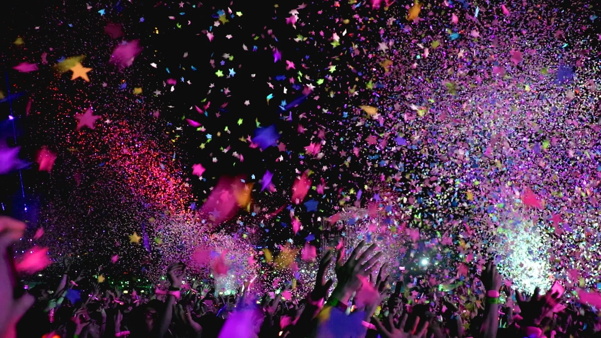 A background with confetti and people with their hands up. Used with slight zoom-in/zoom-out animation.